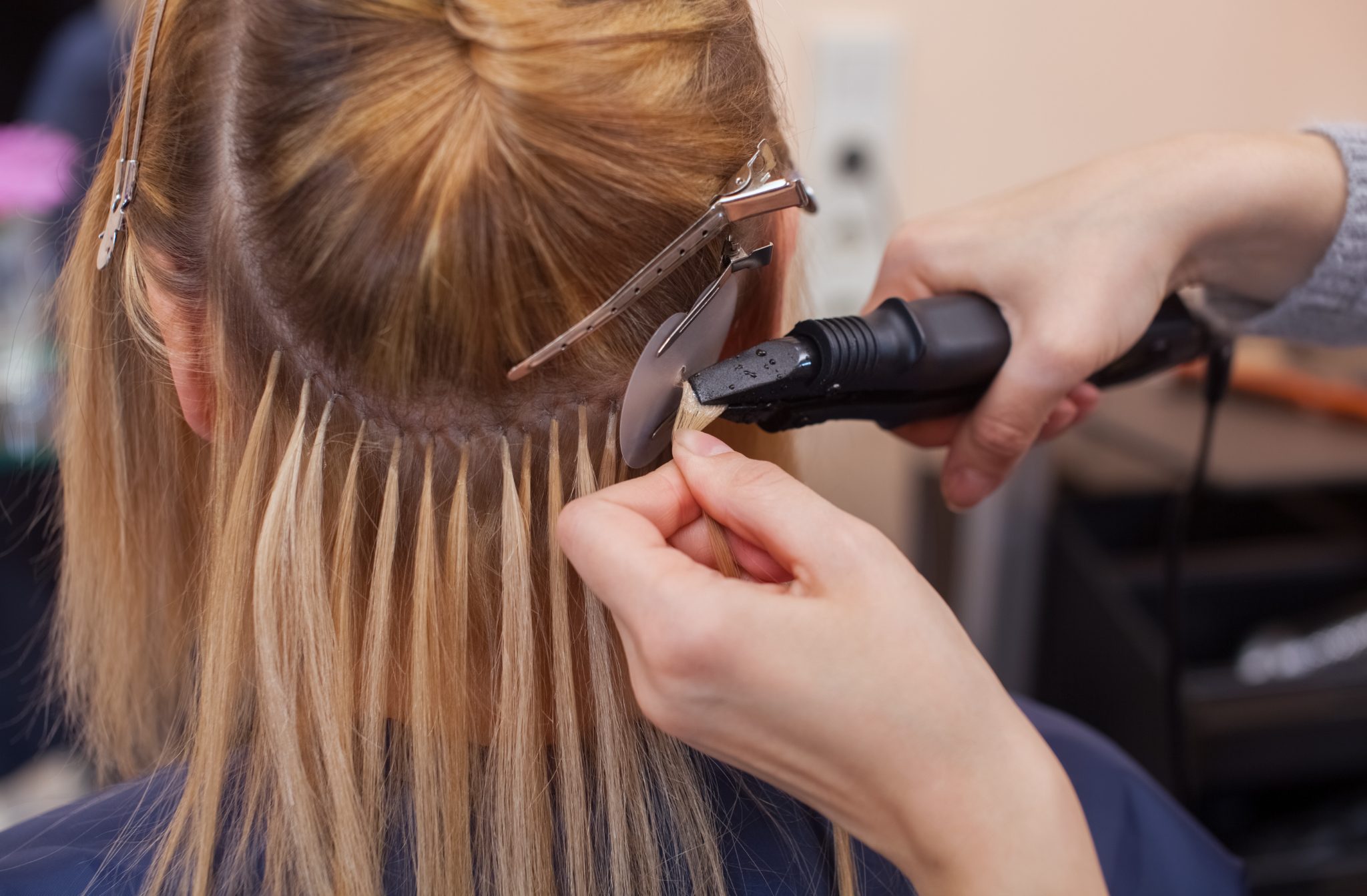 Hair extension application with keratin bonds being attached to natural hair
